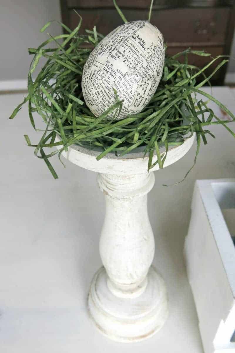 Some faux grass and an upcycled Easter egg make this a simple Easter centerpiece