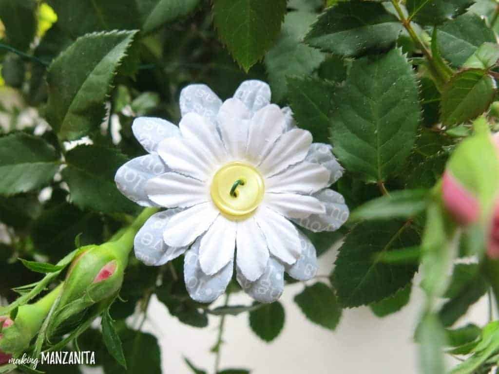 A close up look at the DIY button flowers we made for this Mother's Day craft idea. These button flowers are made with paper flowers, buttons, and floral wire.