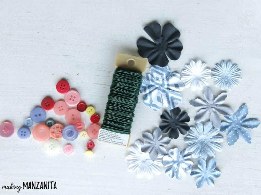 Supplies needed to make this "moms are like buttons" craft: some colorful buttons, fabric flowers, and craft wire