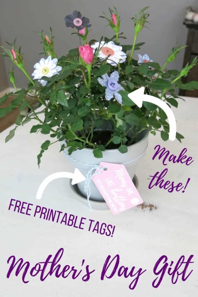 Image shows a potted rose plant on a table. Overlay text on the image says "make these" with an image pointing to the DIY button flowers in the potted plant. Another arrow points to the free printable gift tags attached to the pot with string.