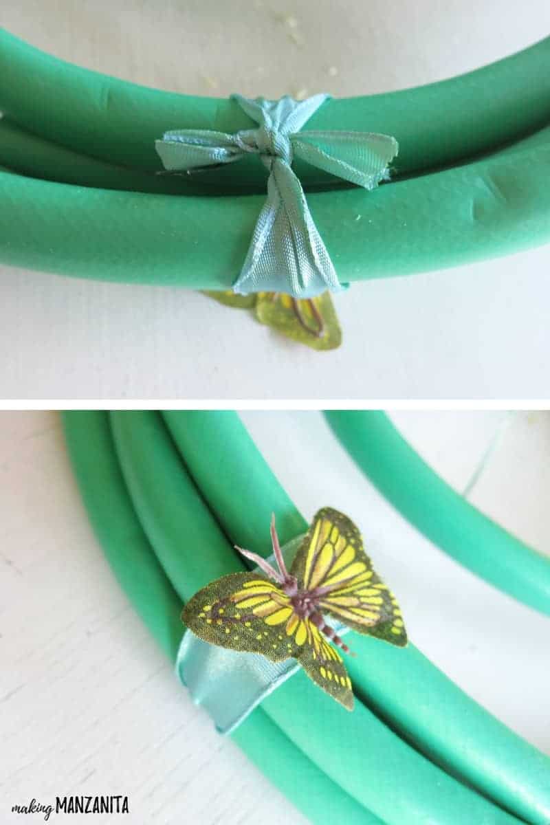 Two images show how to attach a fake butterfly charm to the garden hose wreath. A piece of blue ribbon is tied around the garden hose, then a butterfly charm is attached to the ribbon.