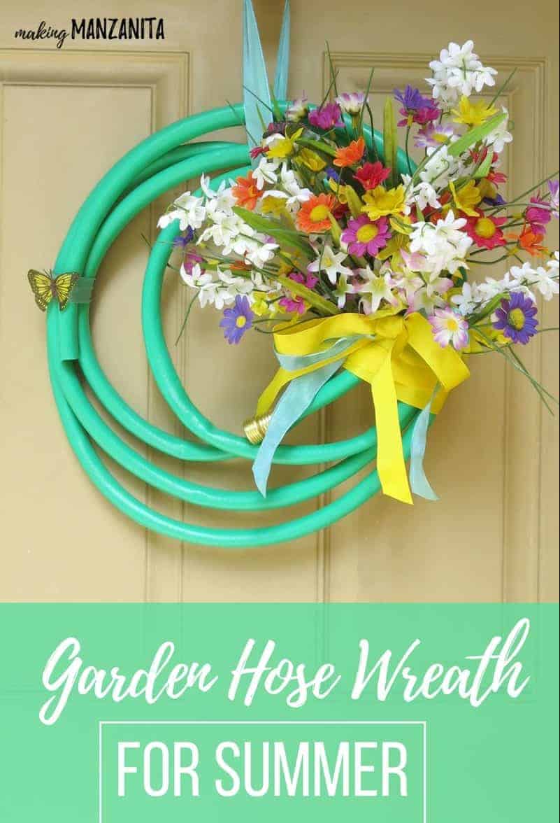 A bright and colorful summer garden hose wreath made from an upcycled garden hose and faux flowers hangs on a front door. Image text reads 