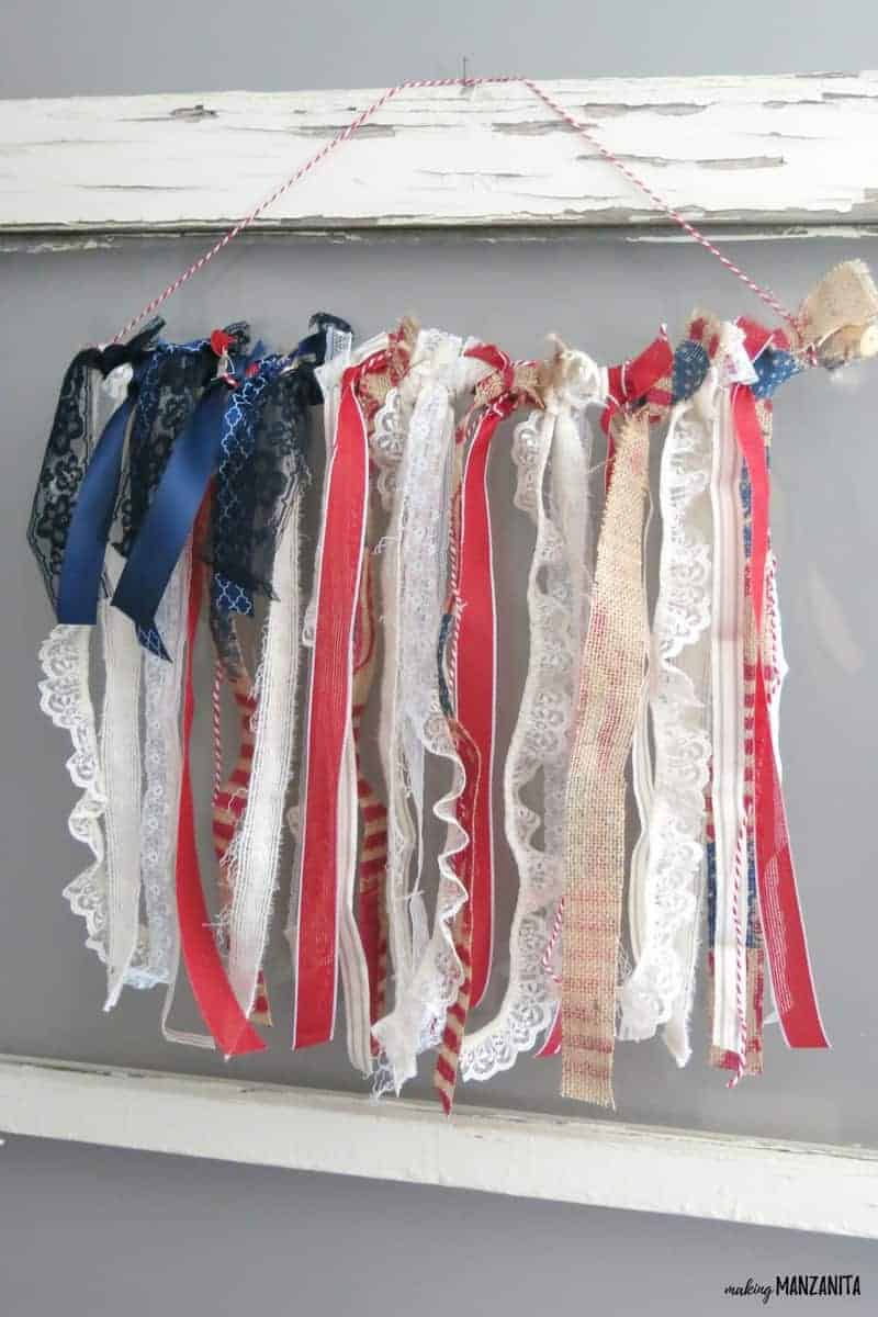 This American flag ribbon hanging is made with different kinds of red, white, and blue ribbon and is perfect for the 4th of july