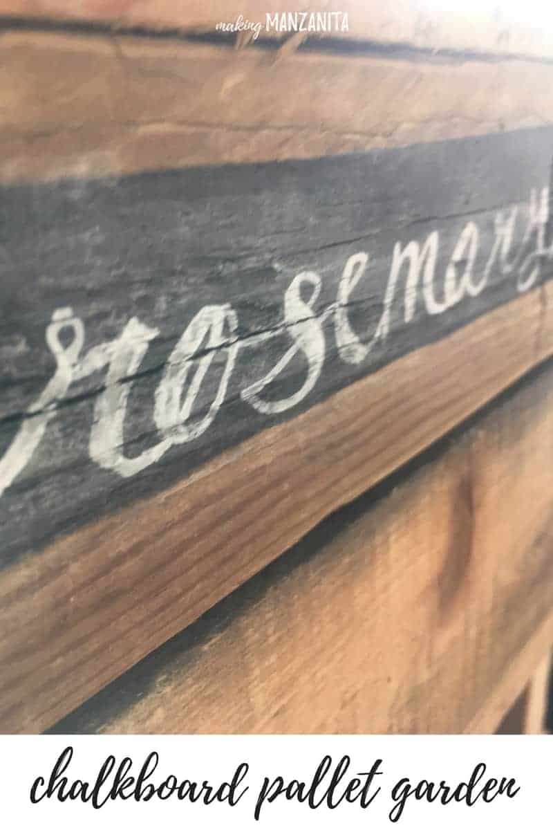 A close-up look at the chalkboard paint on our pallet garden, and the word "rosemary" written in chalk on the pallet shelf.