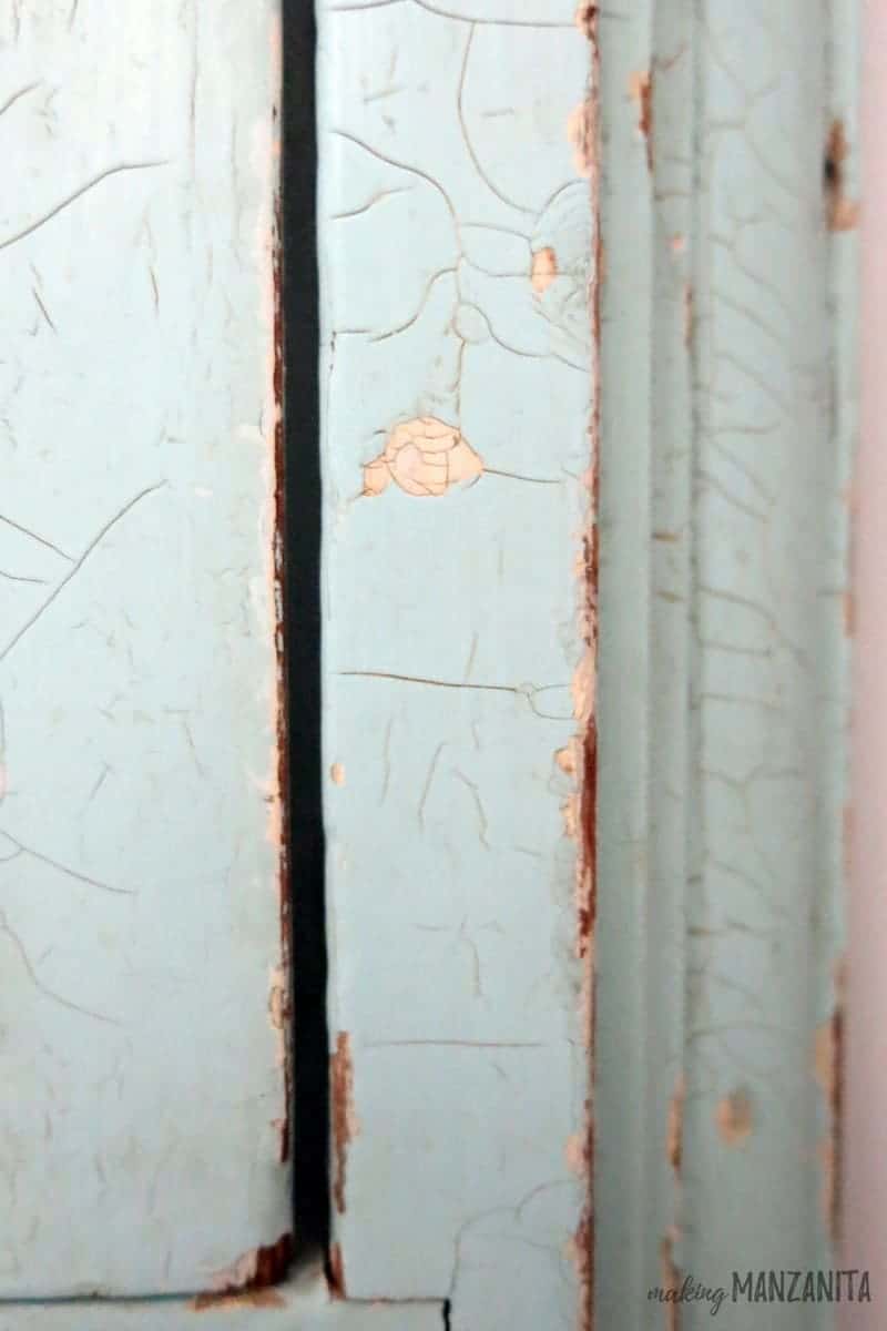 A close up look at the chipped mint green paint on the vintage medicine cabinet in our bathroom.