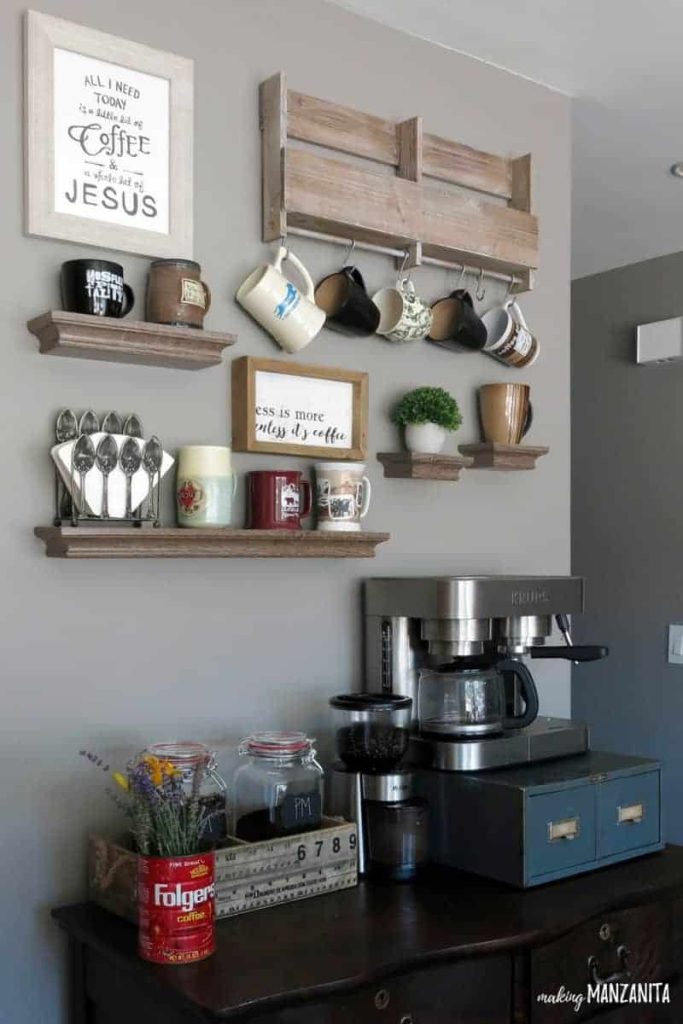 Vintage dresser being used as a coffee bar with wall shelves and hooks above it for mug storage with gray painted walls with Fashion Gray paint color from Behr Paint