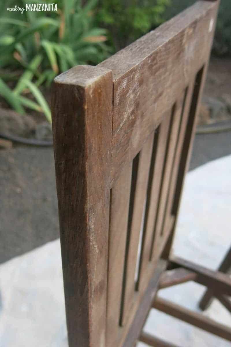 A closer look at the finish on a recycled chair back. The finish of this wooden chair is scratched and tarnished and needs to be restained.