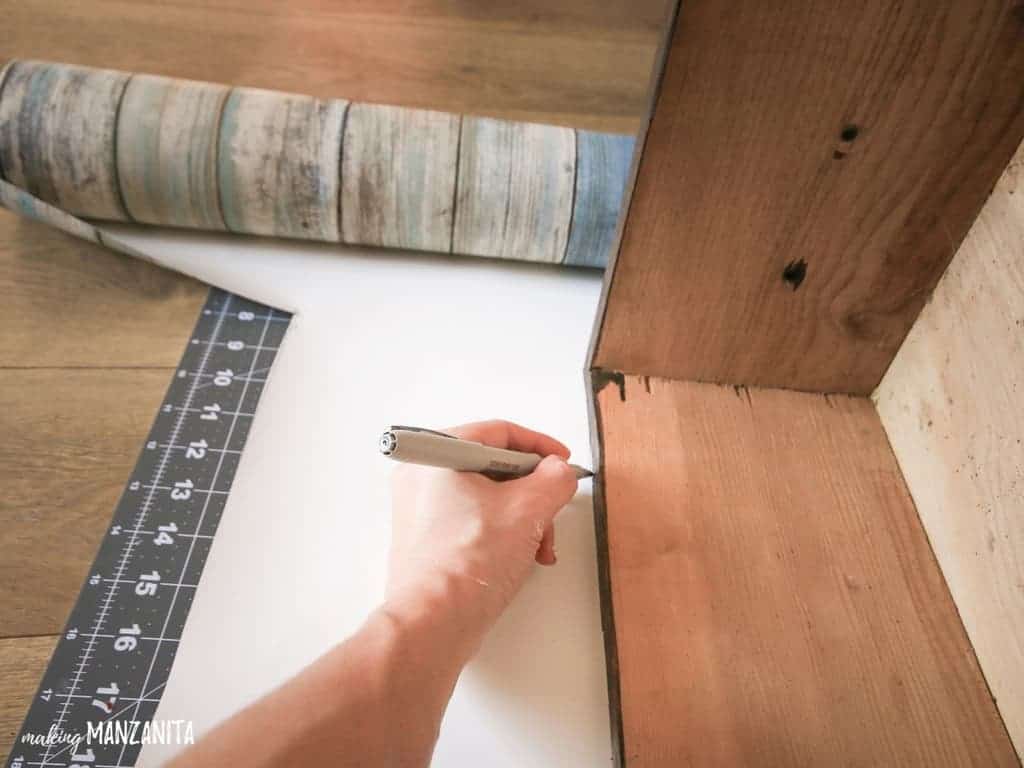 Trace the side of the dresser drawer on the back of peel and stick wallpaper