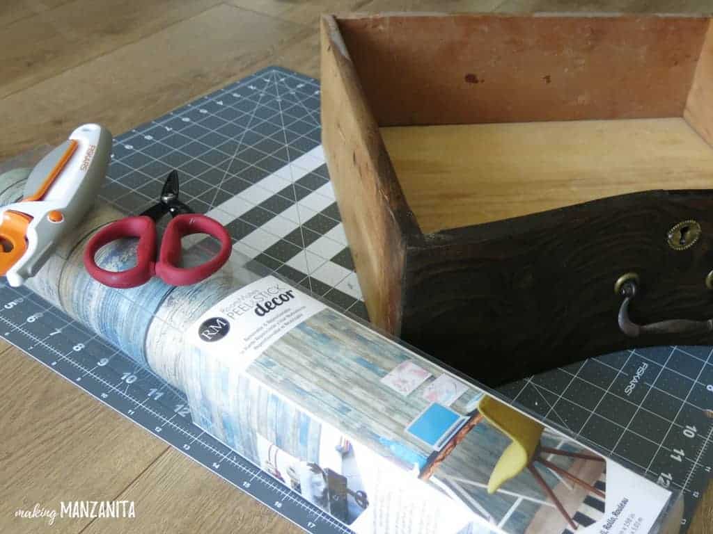 Supplies needed for adding peel and stick wallpaper to the sides of dresser drawers.