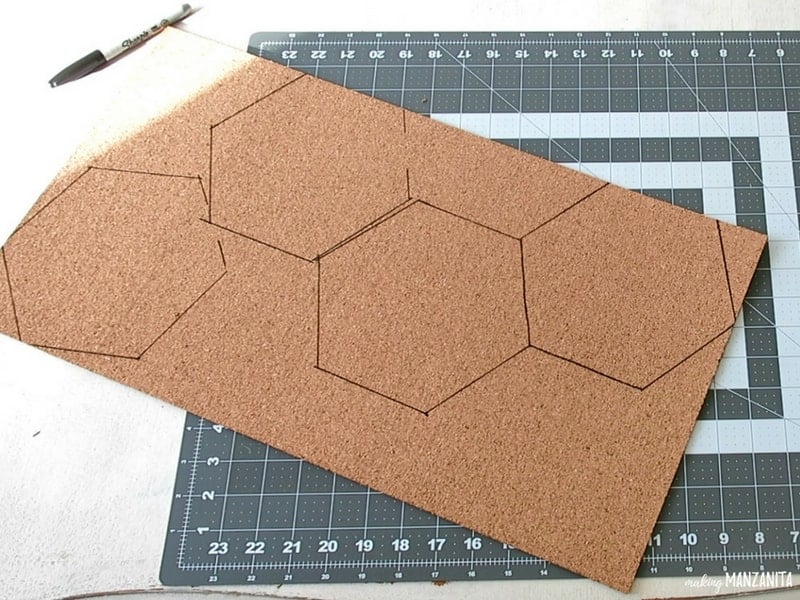 Cork board with hexagon drawings on top of the cutting mat