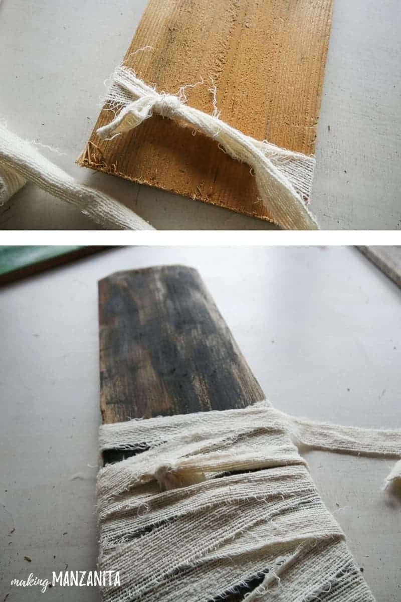 Wrap ripped fabric around an old fence board to create a mummy Halloween decoration.