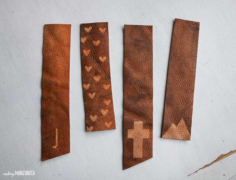 DIY leather bookmarks decorated with hearts, letters, and mountain shapes