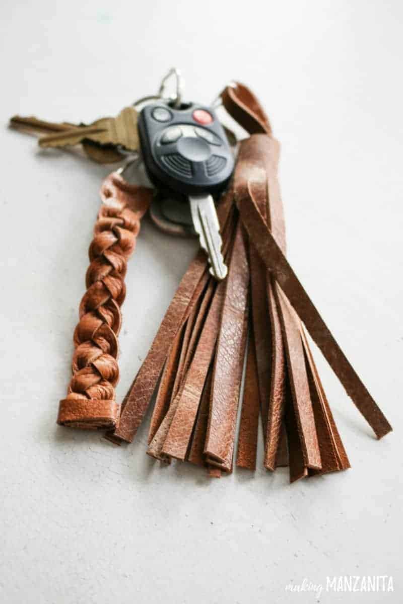 A braided leather keychain and a leather tassel keychain attached to a set of car keys
