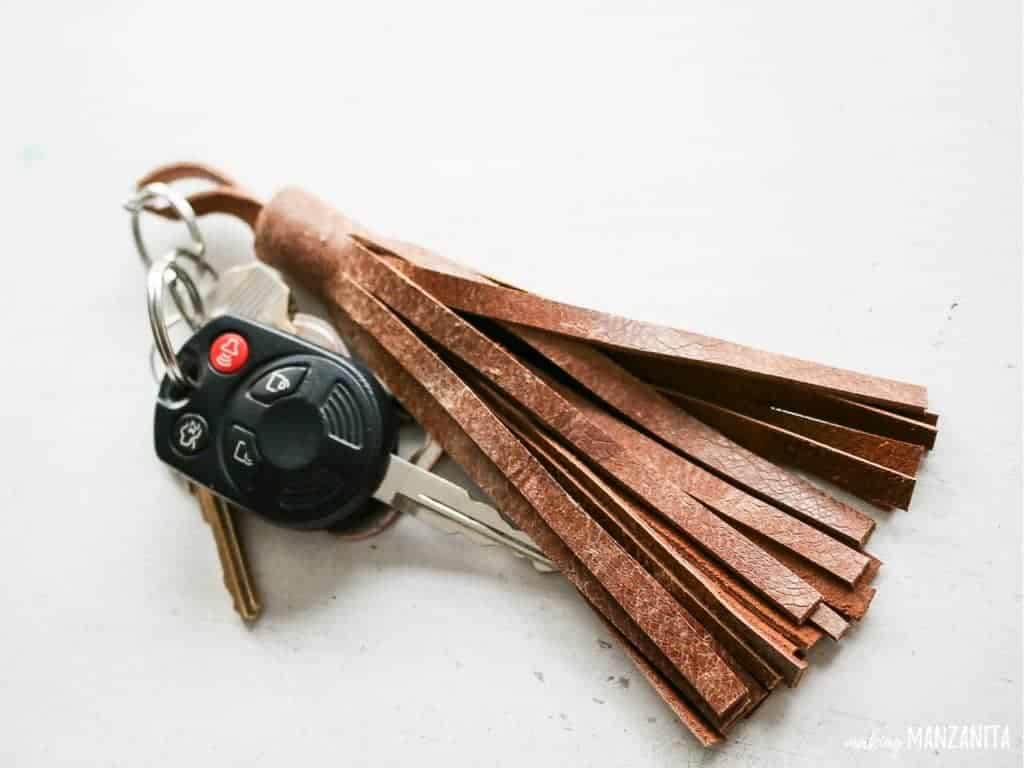 A cute DIY leather tassel keychain attached to a set of car keys