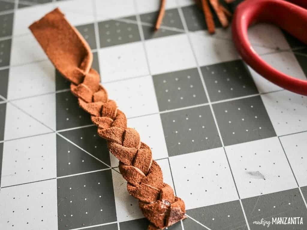 A braided leather keychain sealed with fabric glue