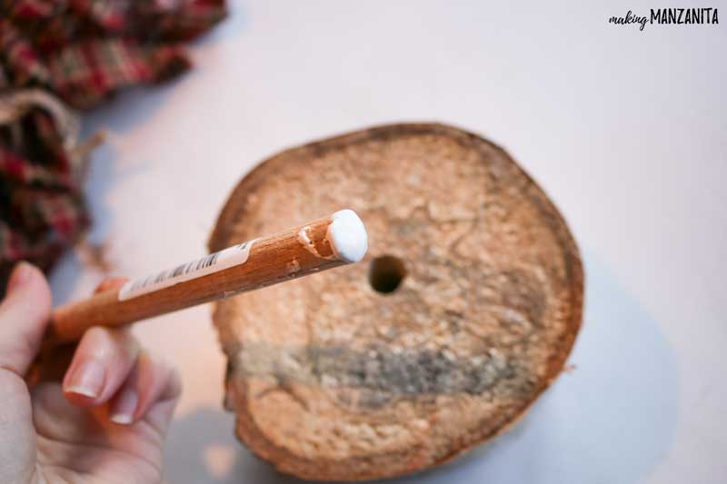 Birch log with hole on the center and the wooden dowel with glue at the tip