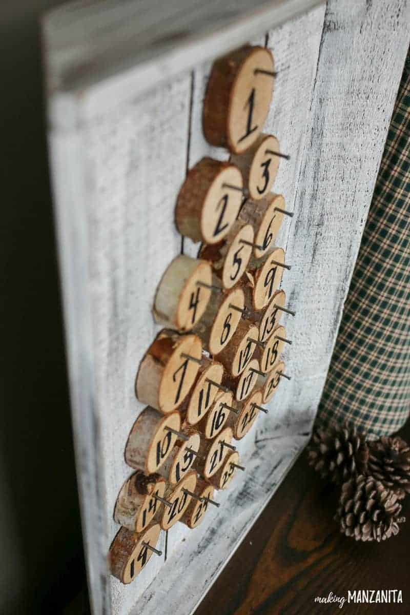 Walnut hollow birch wood rounds nailed to the farmhouse painted wood tray for the Christmas advent countdown calendar