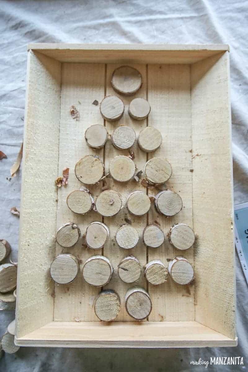 Small wood rounds arranged in tree shape on walnut hollow tray