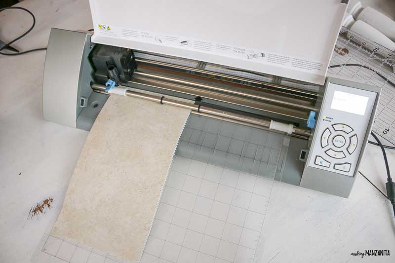 Use a silhouette cameo cutter to cut the contact paper you need to make this Joy Christmas sign