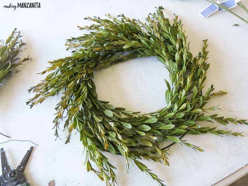 This farmhouse style wreath looks great with a full wire frame of faux tea leaves