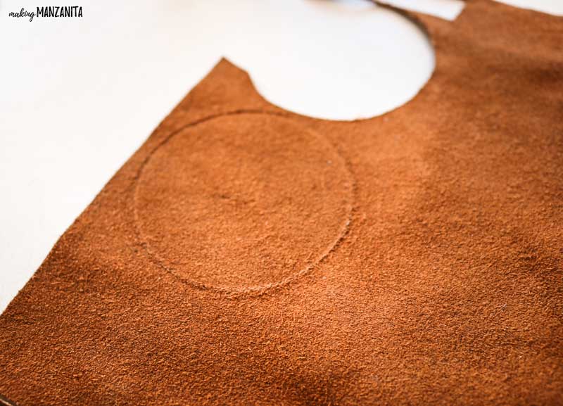 Cut circles in the leather sheet to create the start of the leather Christmas ornament
