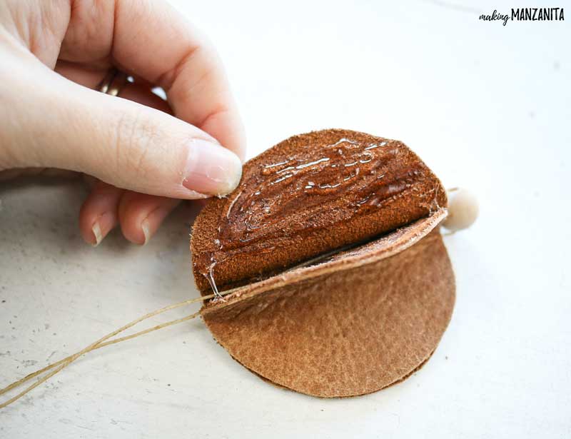 Glue the other side of the leather circles to create a folded look on your leather Christmas ornament