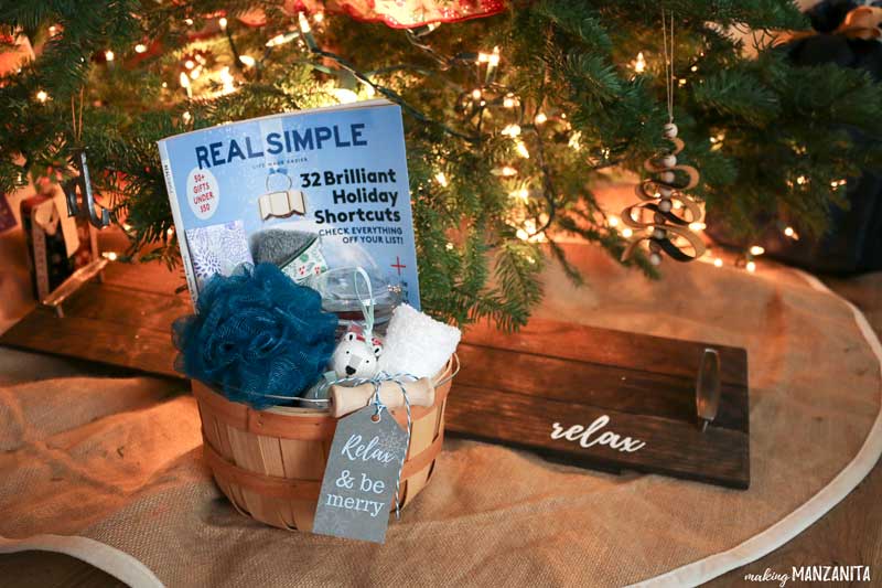 Relaxation gift basket with gift tag under the Christmas tree paired with DIY bathtub tray