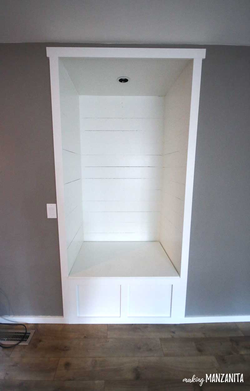 A look at our finished living room reading nook! We transformed an alcove in our living room into a reading nook with white shiplap walls and a built in bench seat with extra storage underneath