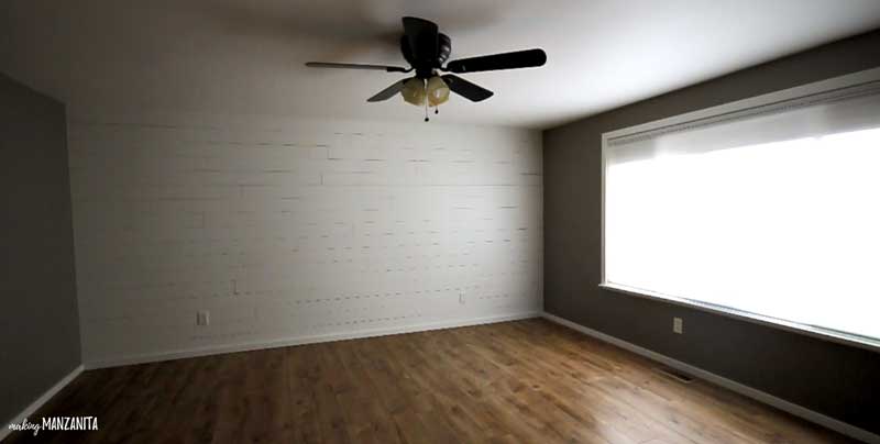 angled shot showing a room with a finished shiplap wall