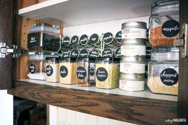 A closer look at our spice cabinet organization! These spice jars are clearly labeled, lined up neatly in the spice cabinet and organized on a convenient metal spice rack.