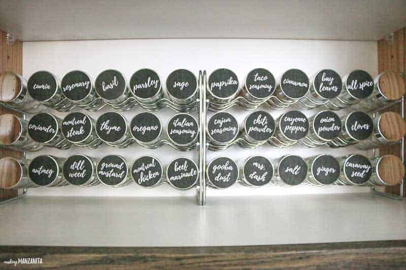 A closer look at our two metal spice racks used in our spice cabinet organization project. These spice racks each hold 18 bottles of spices, all clearly labeled with stickers on the top of the jar.