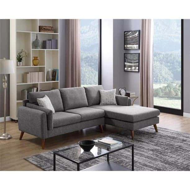 This mid-century modern gray sectional sofa is sleek and comfy with thin wooden legs and a chaise lounge seat.