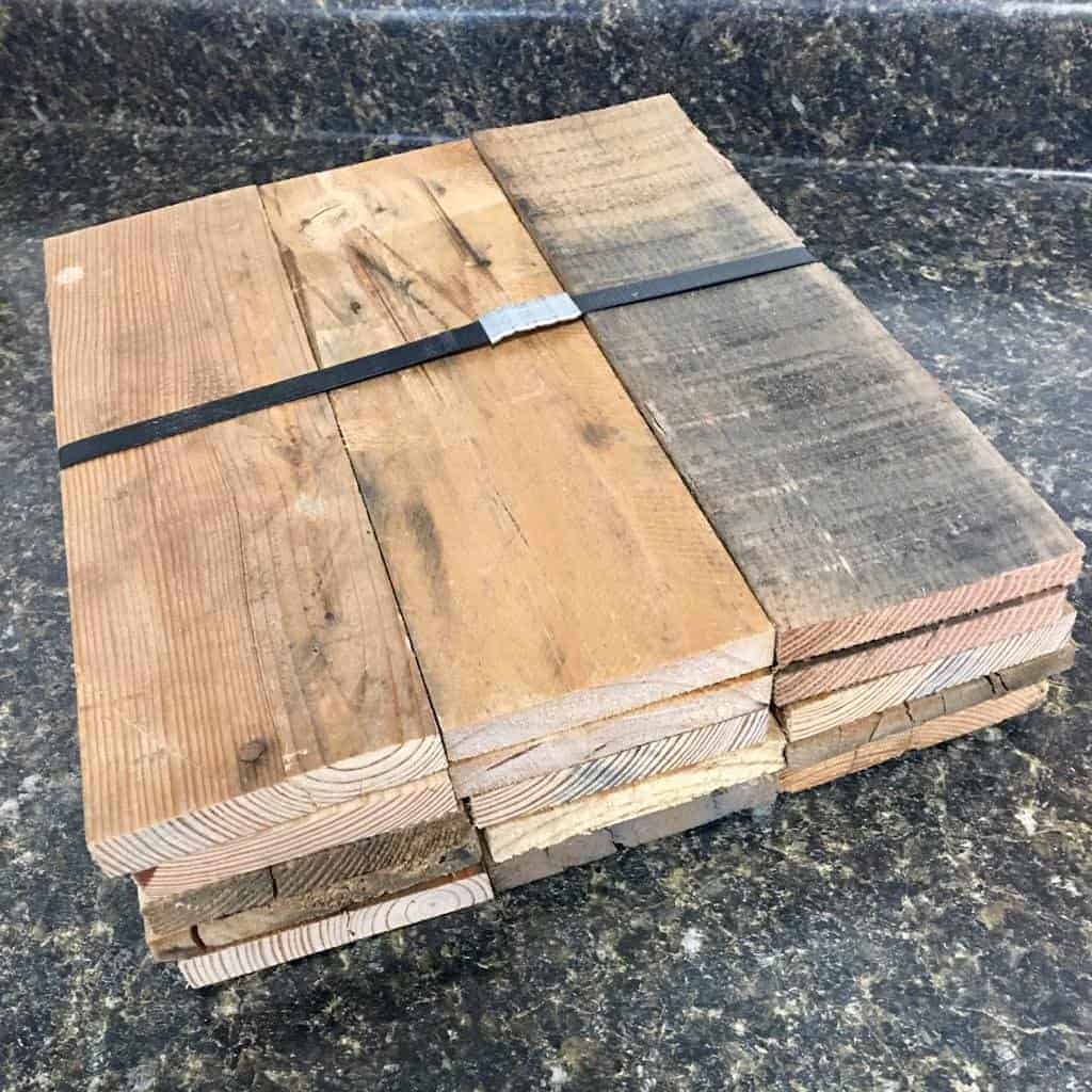 A picture of a bundle of pallet wood that can be used to make a DIY Pallet Shelf.