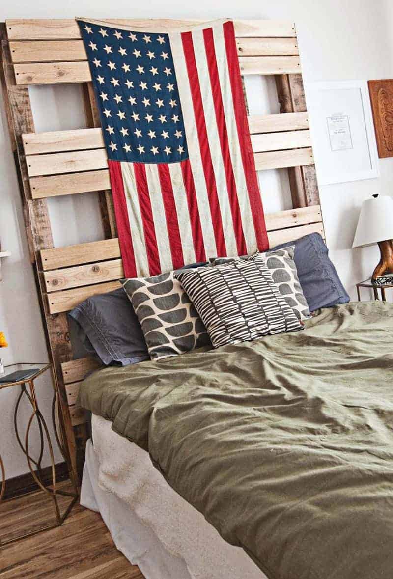 If you want a casual laid back look in your bedroom, try decorating with a wood pallet headboard, vintage flag hanging as over the bed decor, olive green bedding