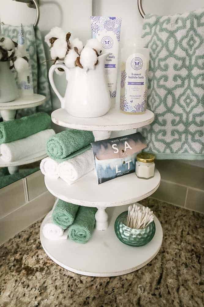 DIY cotton stems made great farmhouse style bathroom decor, like on this vintage three tiered toiletries stand