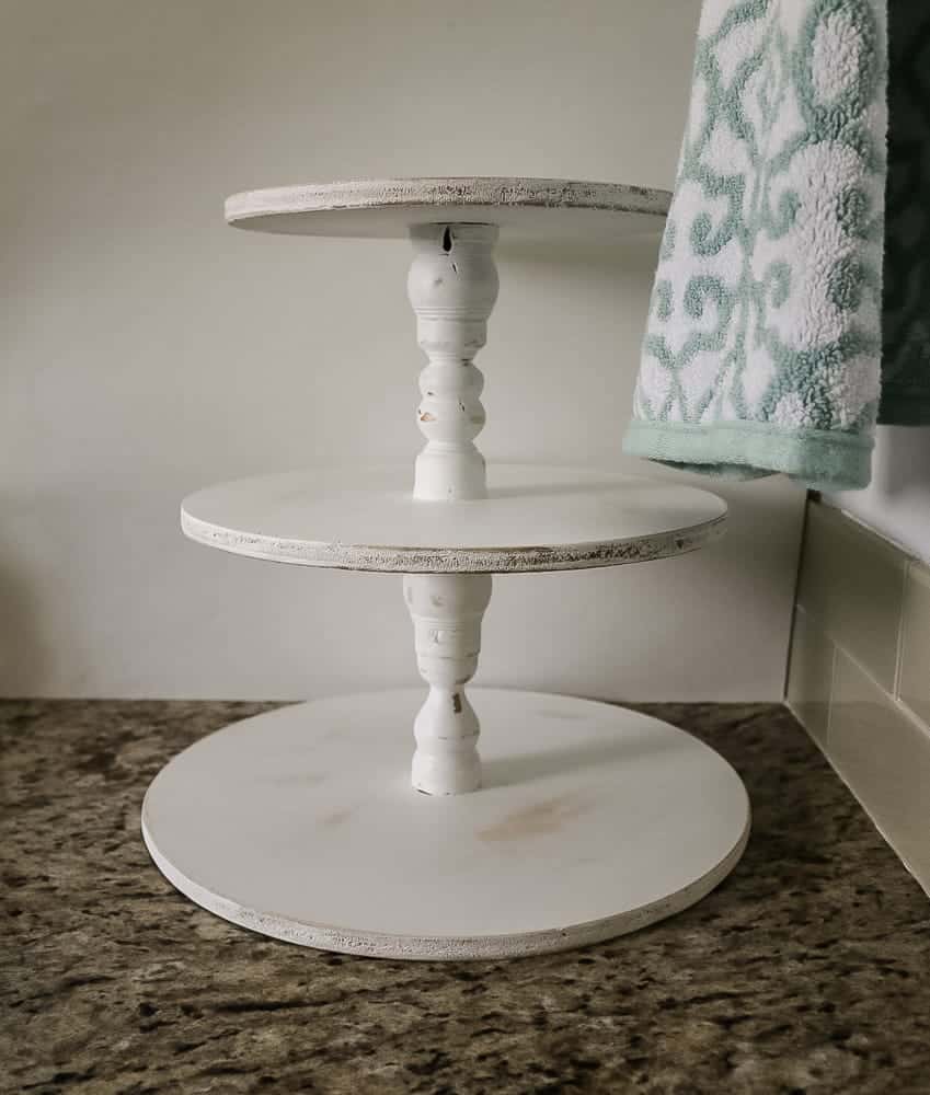 The finished three tier stand, painted with white paint and distressed to give it a vintage farmhouse look.