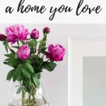 Frame on table with vase next to it with pink flowers with text overlay that says how to make your house a home you love