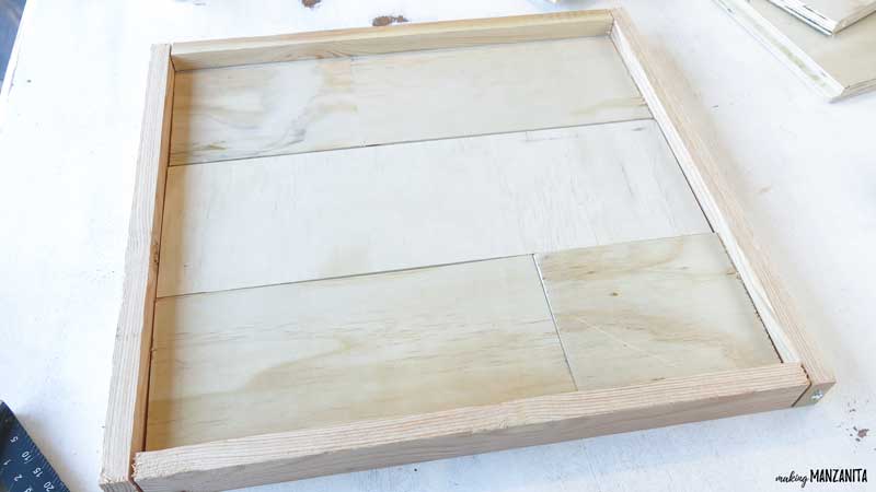 The shiplap was arranged in a square and then a frame made with furring strips went around