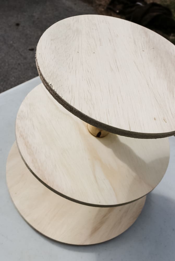 A top view of the unfinished wood three tier stand, with three different sized circle layers.