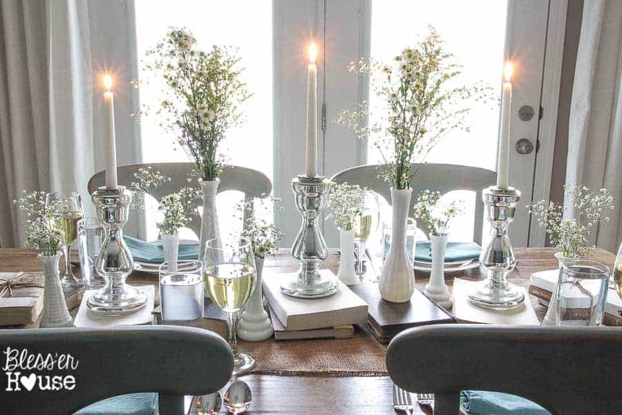 Book, burlap and milk glass with plates and napkins as tablescapes