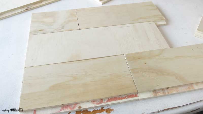 Start by laying the leftover shiplap out on a table and arranging for the wood sign
