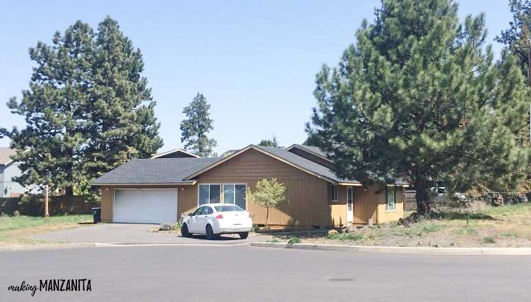 Before painting our home exterior - a tan ranch style home surrounded by trees.