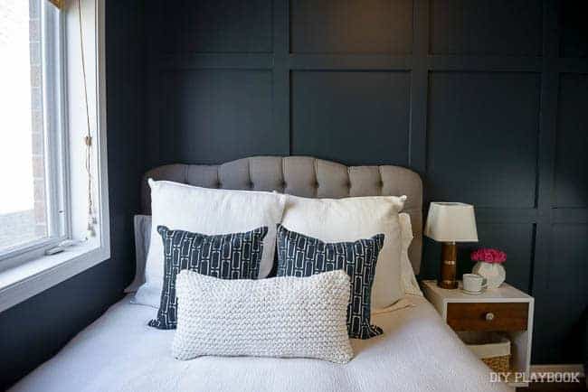 if you're looking for above your bed DIY ideas, you could add a dark square board and batten accent wall behind bed. It looks great with gray upholstered bed with white bedding