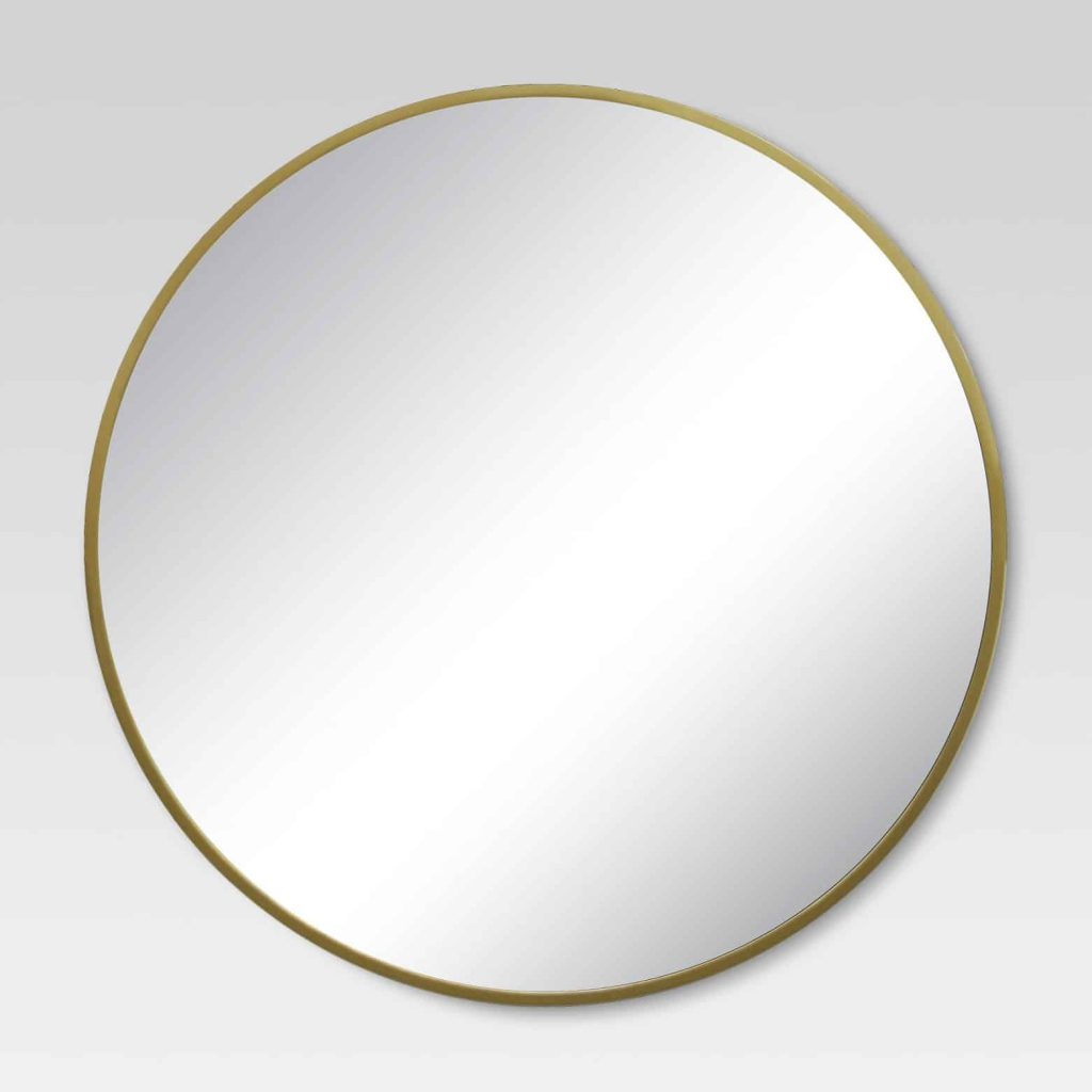 Struggling with what to put behind bed? Why not a large round mirror like this gold wall mirror from Project 62 at Target?