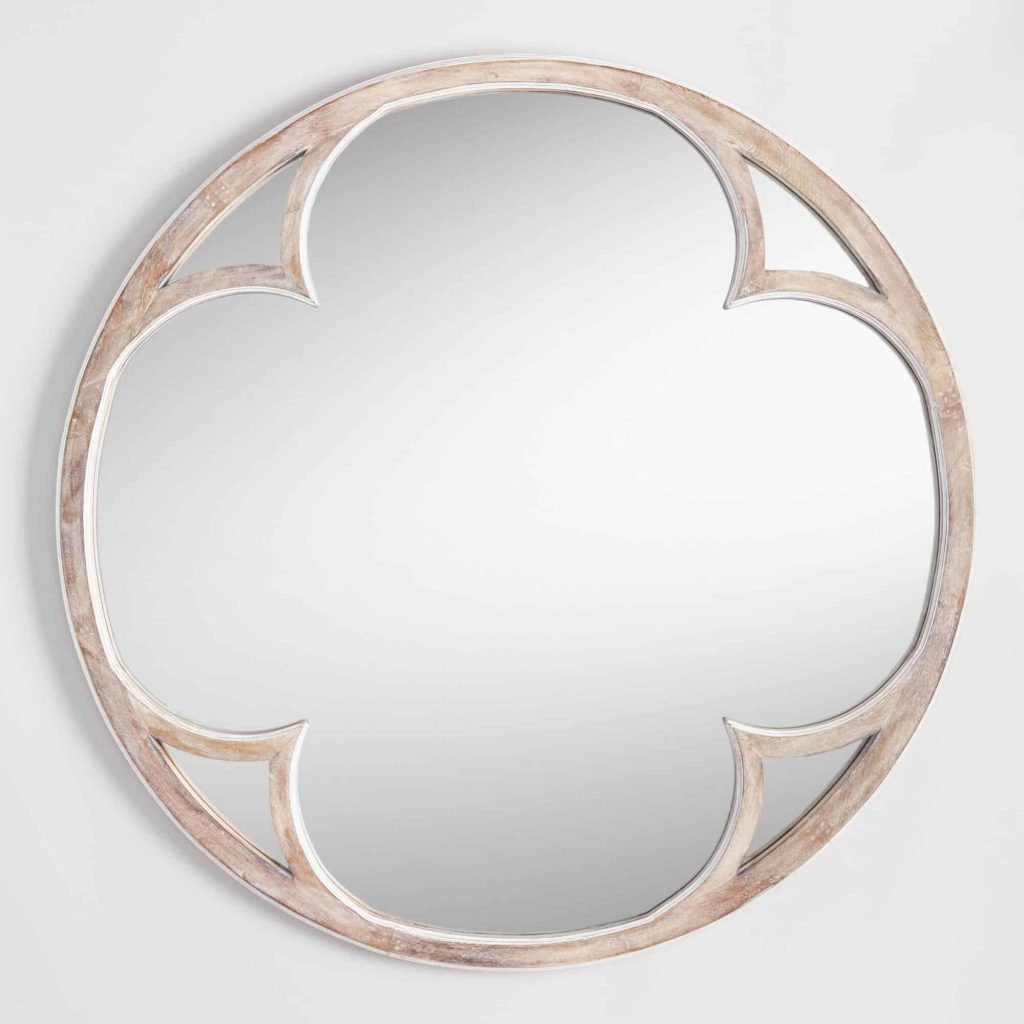 I love this round Sorrento mirror with a white washed finish from World Market to go as decor above the bed