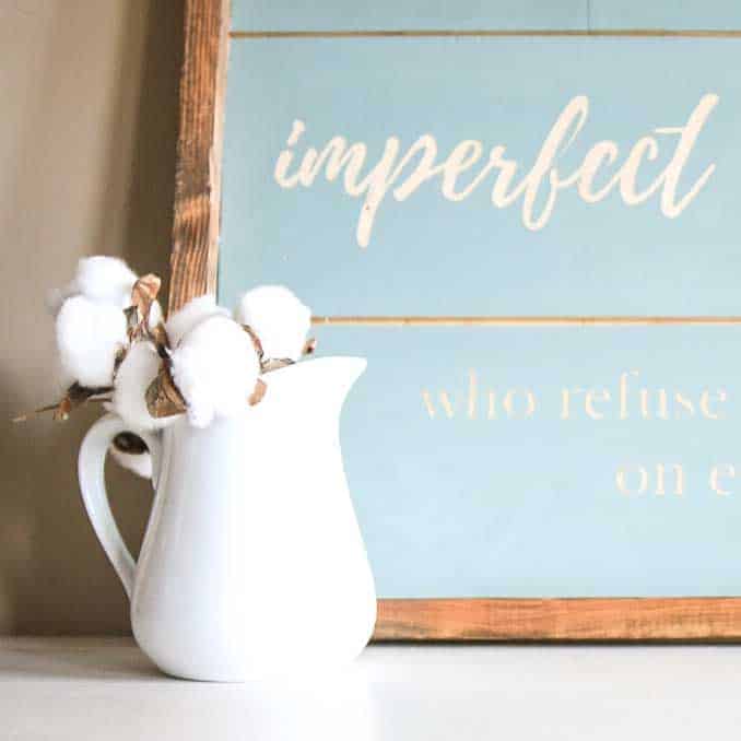 This blue DIY shiplap sign looks great paired with this white vase filled with faux cotton stems