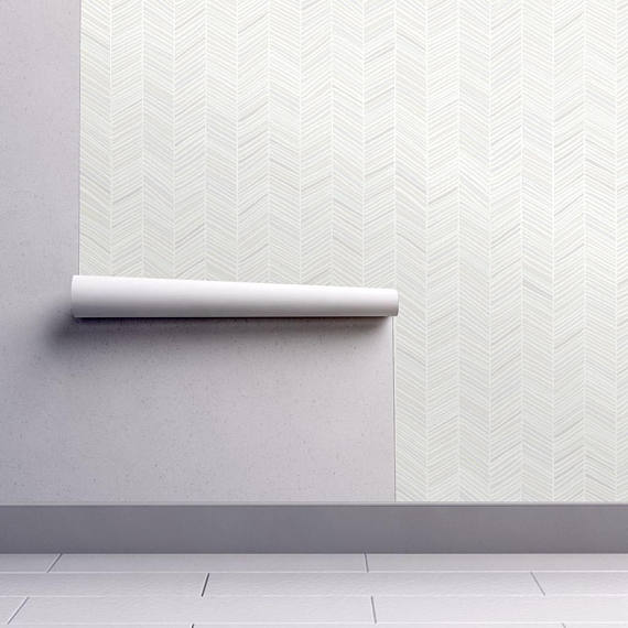 This simple herringbone patterned wallpaper is a great option for the wall above your master bed