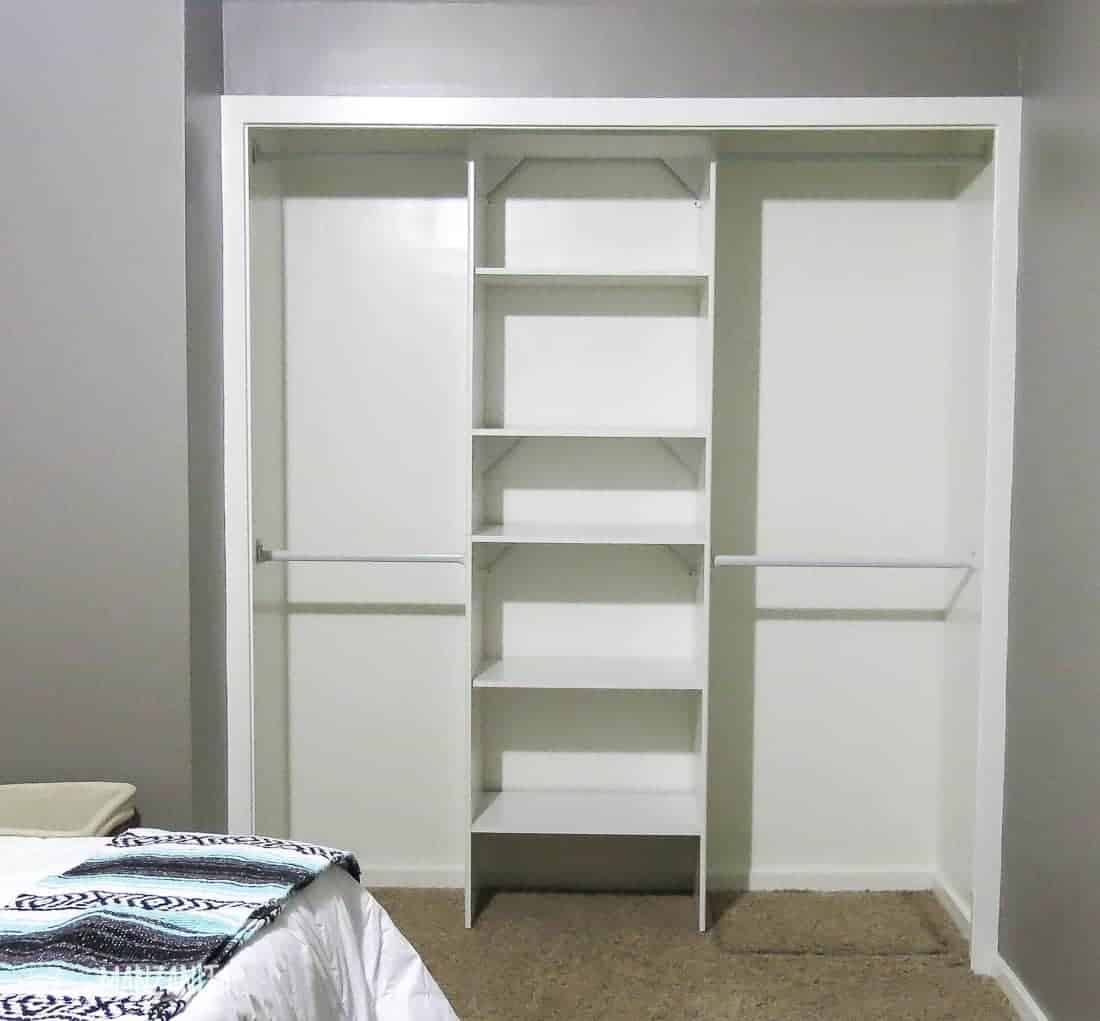 A look into the organized closet system in our master bedroom closet -- two separate spaces for hanging clothes, with a third section of shelving in the middle for folding and storage.