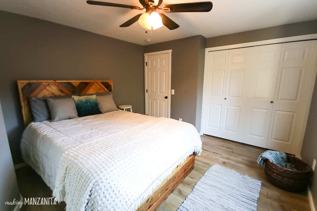 Another view of the updated master bedroom with a new king-size bed, hardwood floors, and large closet space.