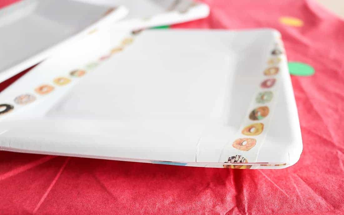 White square paper plates decorated with strips of donut themed washi tape.